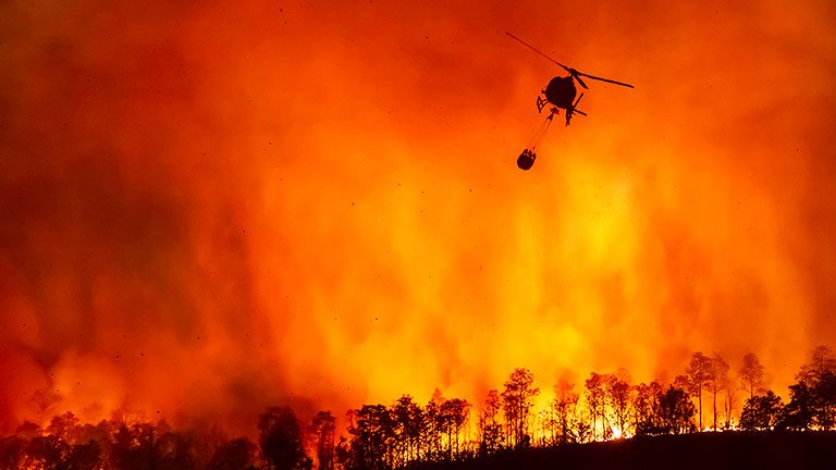 Global warming: Wildfire fighting helicopter